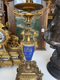 A French gilt bronze three-piece clock garniture crowned with a lady holding a jewelry box, 19th C.