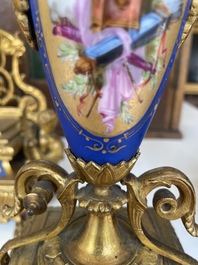 A French gilt bronze three-piece clock garniture crowned with a lady holding a jewelry box, 19th C.