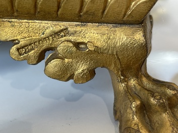 A French gilt bronze three-piece clock garniture crowned with a lady holding a jewelry box, 19th C.