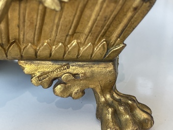 A French gilt bronze three-piece clock garniture crowned with a lady holding a jewelry box, 19th C.