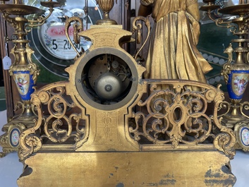 A French gilt bronze three-piece clock garniture crowned with a lady holding a jewelry box, 19th C.