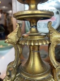 A French gilt bronze three-piece clock garniture crowned with a lady holding a jewelry box, 19th C.