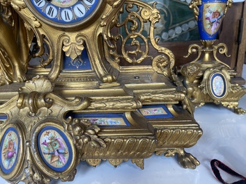 A French gilt bronze three-piece clock garniture crowned with a lady holding a jewelry box, 19th C.