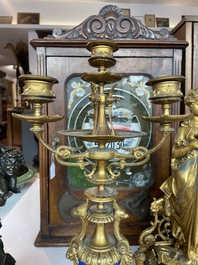 A French gilt bronze three-piece clock garniture crowned with a lady holding a jewelry box, 19th C.