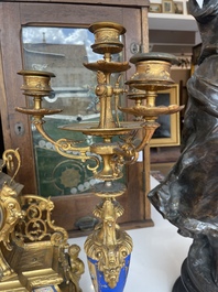 A French gilt bronze three-piece clock garniture crowned with a lady holding a jewelry box, 19th C.