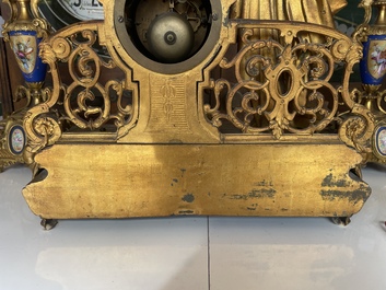 A French gilt bronze three-piece clock garniture crowned with a lady holding a jewelry box, 19th C.