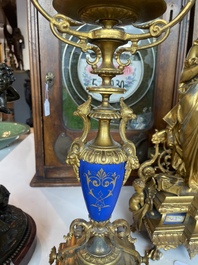 A French gilt bronze three-piece clock garniture crowned with a lady holding a jewelry box, 19th C.