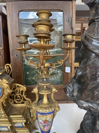 A French gilt bronze three-piece clock garniture crowned with a lady holding a jewelry box, 19th C.