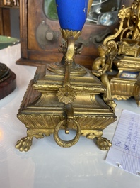 A French gilt bronze three-piece clock garniture crowned with a lady holding a jewelry box, 19th C.