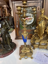 A French gilt bronze three-piece clock garniture crowned with a lady holding a jewelry box, 19th C.