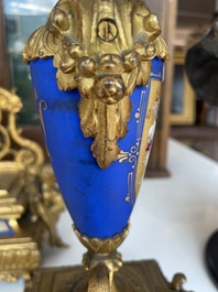 A French gilt bronze three-piece clock garniture crowned with a lady holding a jewelry box, 19th C.