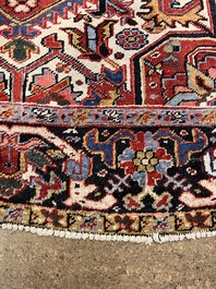 A Persian Heriz rug with floral design, wool on cotton, 20th C.