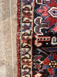 A Persian Heriz rug with floral design, wool on cotton, 20th C.