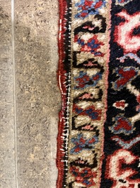 A Persian Heriz rug with floral design, wool on cotton, 20th C.