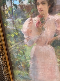 Louise De Hem (1866-1922): Portrait of a lady in a pink dress with a flower in her hand in a garden, pastel on paper marouflated on canvas