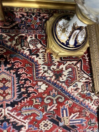 A Persian Heriz rug with floral design, wool on cotton, 20th C.