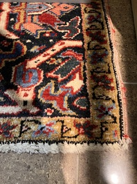 A Persian Heriz rug with floral design, wool on cotton, 20th C.