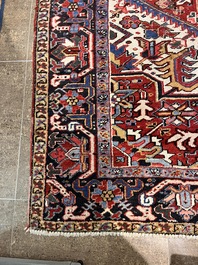 A Persian Heriz rug with floral design, wool on cotton, 20th C.