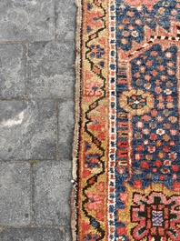 Een Perzisch Heriz tapijt met floraal decor, wol op katoen, 20ste eeuw