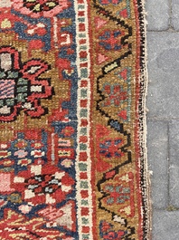 Een Perzisch Heriz tapijt met floraal decor, wol op katoen, 20ste eeuw
