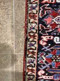 A Persian Heriz rug with floral design, wool on cotton, 20th C.