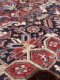 A Persian Heriz rug with floral design, wool on cotton, 20th C.