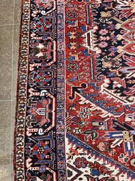 A Persian Heriz rug with floral design, wool on cotton, 20th C.