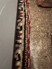 A Persian Heriz rug with floral design, wool on cotton, 20th C.