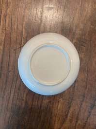 A pair of Chinese famille rose saucers with butterflies on a ruby red ground, 19th/20th C.