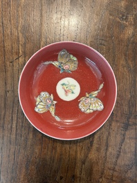 A pair of Chinese famille rose saucers with butterflies on a ruby red ground, 19th/20th C.