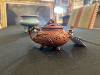 A Chinese Yixing stoneware tripod teapot and reticulated cover, 18th C.