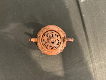 A Chinese Yixing stoneware tripod teapot and reticulated cover, 18th C.