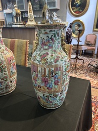A pair of Chinese Canton famille rose vases with palace scenes and floral design, 19th C.