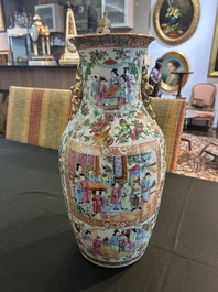 A pair of Chinese Canton famille rose vases with palace scenes and floral design, 19th C.