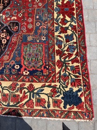 A Persian Bakhtiar rug with floral design, wool on cotton, 20th C.