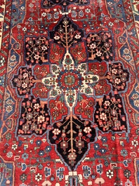 A Persian Bakhtiar rug with floral design, wool on cotton, 20th C.