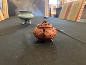 A Chinese Yixing stoneware tripod teapot and reticulated cover, 18th C.