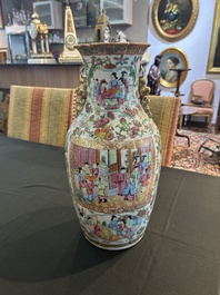 A pair of Chinese Canton famille rose vases with palace scenes and floral design, 19th C.