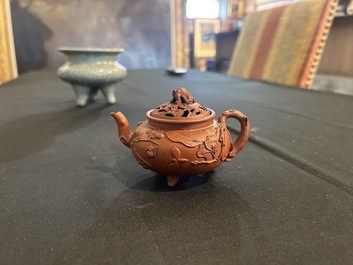 A Chinese Yixing stoneware tripod teapot and reticulated cover, 18th C.
