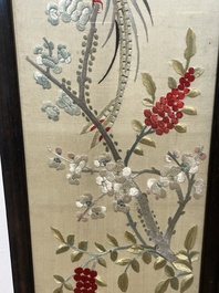 Four Chinese vertical silk embroideries with birds among blossoming branches, 20th C.