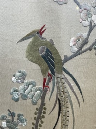 Four Chinese vertical silk embroideries with birds among blossoming branches, 20th C.