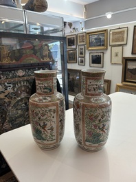 A pair of Chinese Canton famille rose vases with birds and butterflies among blossoming branches and antiques, 19th C.