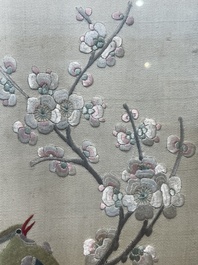 Four Chinese vertical silk embroideries with birds among blossoming branches, 20th C.