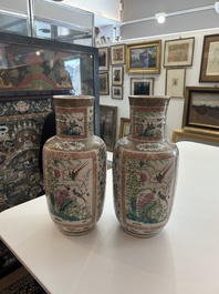 A pair of Chinese Canton famille rose vases with birds and butterflies among blossoming branches and antiques, 19th C.