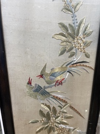 Four Chinese vertical silk embroideries with birds among blossoming branches, 20th C.