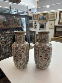 A pair of Chinese Canton famille rose vases with birds and butterflies among blossoming branches and antiques, 19th C.