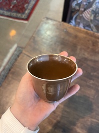 Five Chinese capucin brown ground cups and saucers with incised floral design, Qianlong