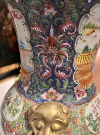 Een paar Chinese Kanton famille rose vazen met blauwe fondkleur, paleissc&egrave;nes en floraal decor omgevormd tot lampen, 19de eeuw