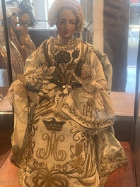 A Spanish polychrome decorated wax Madonna and Child adorned in brocade, 19th C.