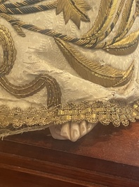 A Spanish polychrome decorated wax Madonna and Child adorned in brocade, 19th C.